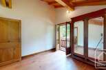 This room features beautiful wooden floors, a rustic wooden ceiling, and a classic wooden wardrobe.