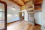 This property boasts a bright and airy room featuring a beautiful wooden floor and ceiling, creating a warm and inviting atmosphere.