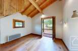 This bright and airy room features a stunning wood-beamed ceiling and natural wood flooring, creating a warm and inviting space.