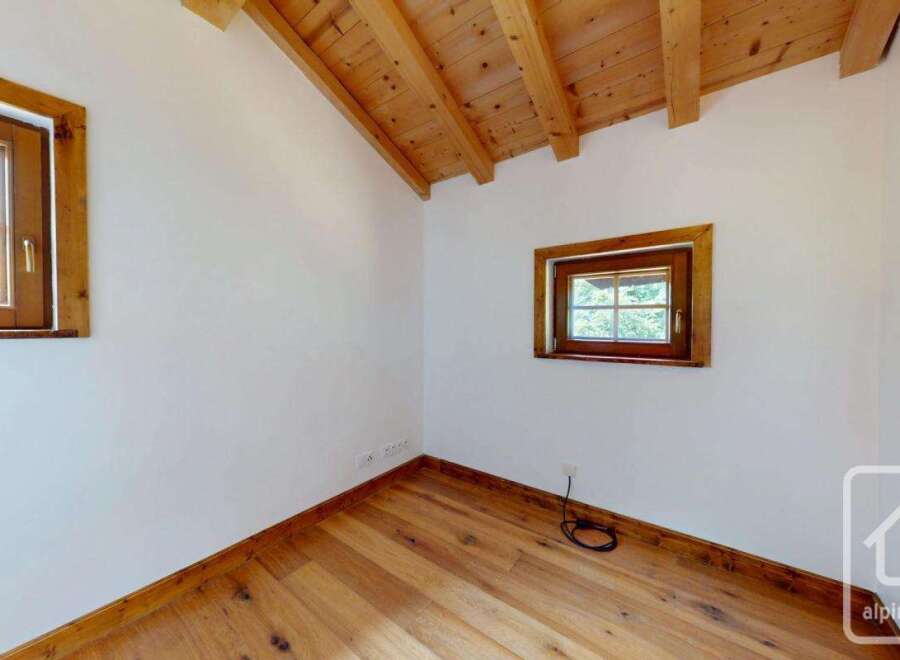 This room features a beautiful wooden floor and ceiling, creating a warm and inviting atmosphere.