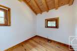 This room features a beautiful wooden floor and ceiling, creating a warm and inviting atmosphere.