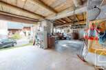 This spacious garage offers ample storage and workspace, perfect for DIY enthusiasts or car enthusiasts.
