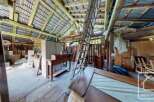 Discover the potential of this rustic barn featuring a spacious interior with exposed wooden beams and a high ceiling.