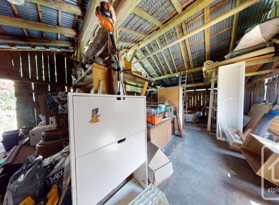 This image showcases the interior of a rustic barn, potentially located on a property for sale.