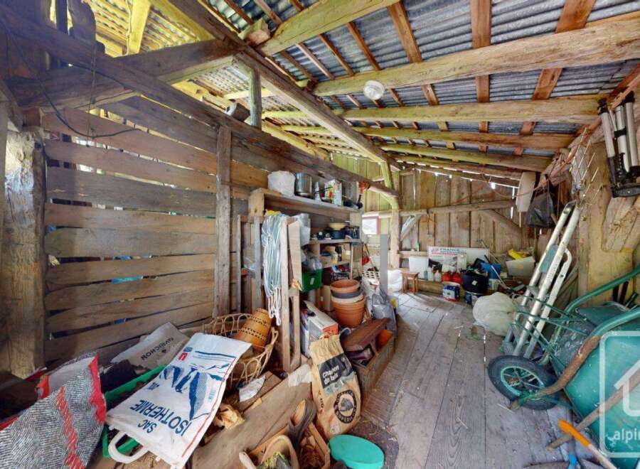Rustic outbuilding or barn interior showcasing a traditional wooden structure with exposed beams.