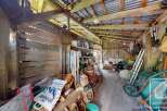 Rustic outbuilding or barn interior showcasing a traditional wooden structure with exposed beams.