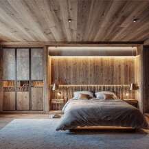 This bedroom showcases a warm, rustic design with extensive use of wood paneling on the walls, ceiling, and flooring, creating a cozy, natural ambiance.