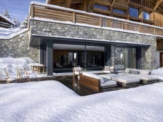 Experience luxury living in this stunning chalet, featuring a seamless blend of natural stone and warm wood accents.
