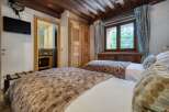 This inviting bedroom features twin beds adorned with plush, faux-fur throws for added comfort.