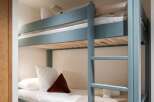 This cozy bunk bed offers a stylish and space-saving solution for any bedroom.
