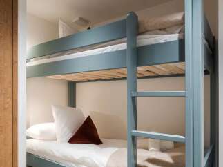 This cozy bunk bed offers a stylish and space-saving solution for any bedroom.
