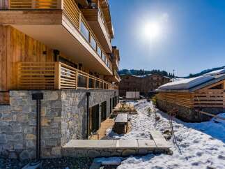 Discover the charm of this stunning property, featuring a beautiful wooden facade and stone accents.