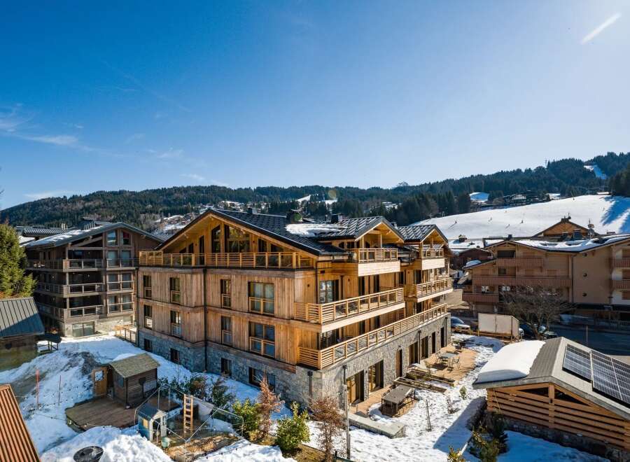 Discover a stunning wooden chalet nestled in a picturesque mountain setting.