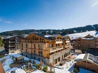 Discover a stunning wooden chalet nestled in a picturesque mountain setting.