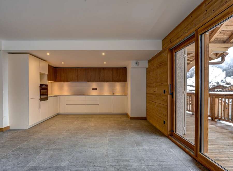Experience luxury living in this stunning property featuring a modern kitchen with sleek cabinetry and high-end appliances.