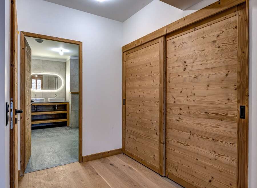 Step into luxury with this stunning property featuring exquisite wooden sliding doors and a beautifully designed bathroom.