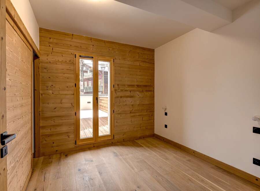 This stunning property boasts a warm and inviting interior with beautiful wooden accents throughout.