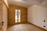 This stunning property boasts a warm and inviting interior with beautiful wooden accents throughout.