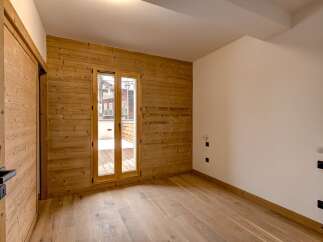 This stunning property boasts a warm and inviting interior with beautiful wooden accents throughout.