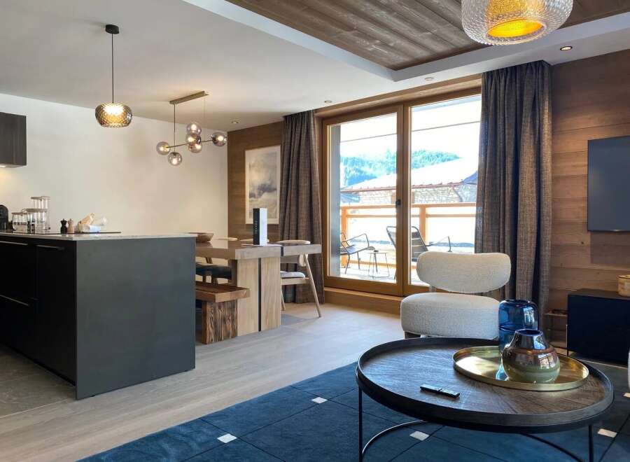 Experience luxury living in this stunning property, featuring a modern kitchen with sleek countertops and a spacious living area.
