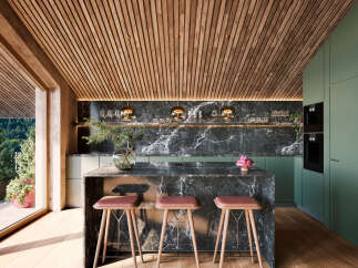 This modern kitchen boasts a striking combination of natural wood and sleek marble finishes.