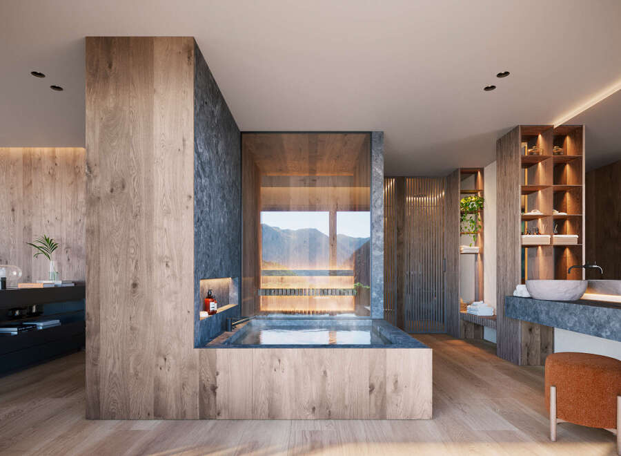 This modern bathroom features a luxurious soaking tub with mountain views, complemented by natural wood finishes and stone accents.