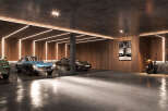 This modern garage is a car lover's dream, showcasing a collection of luxury vehicles under sleek lighting.