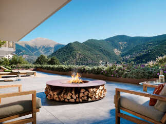 Luxury outdoor living space with a modern fire pit featuring integrated wood storage, perfect for enjoying mountain views.