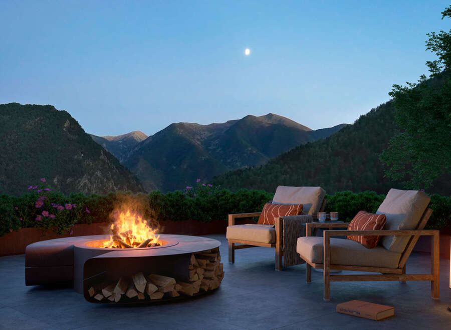 Experience luxury living with this stunning outdoor space featuring a modern fire pit, comfortable seating, and breathtaking mountain views.