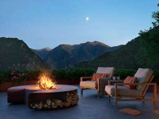 Experience luxury living with this stunning outdoor space featuring a modern fire pit, comfortable seating, and breathtaking mountain views.