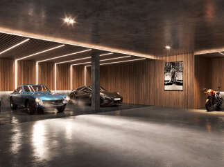 This modern garage is a car lover's dream, showcasing a collection of luxury vehicles under sleek lighting.