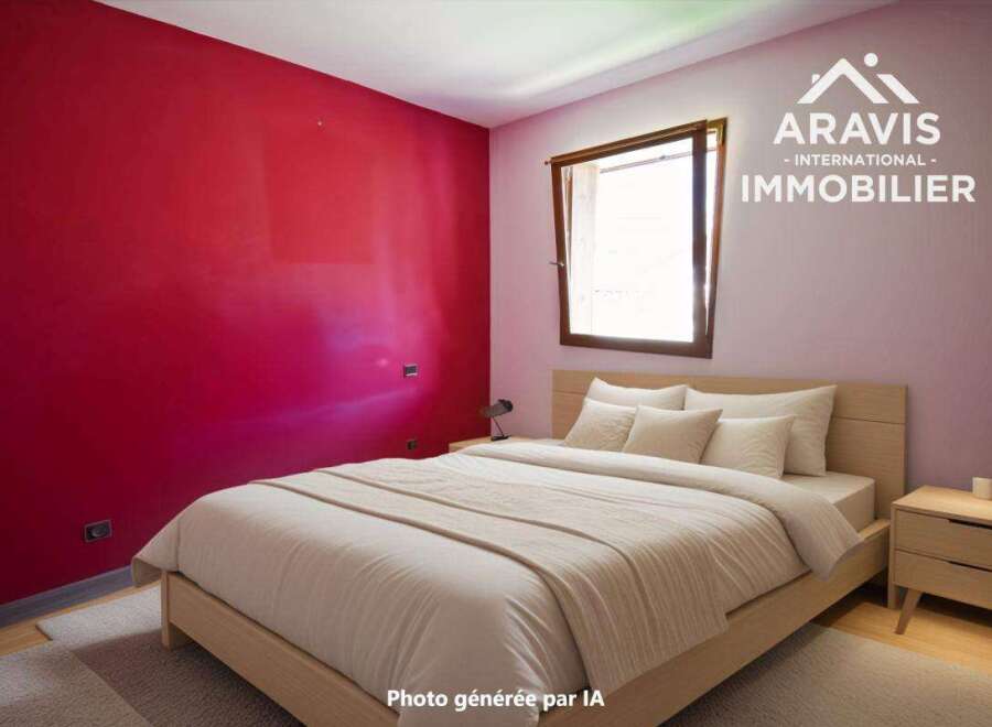 Discover this charming bedroom featuring a vibrant red accent wall, creating a bold and inviting atmosphere.