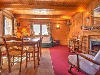 Step into this charming cabin featuring rich wood paneling and flooring, creating a warm and inviting ambiance.
