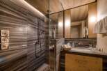 This bathroom showcases a luxurious design with a focus on natural materials.