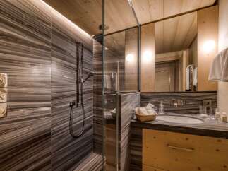 This bathroom showcases a luxurious design with a focus on natural materials.