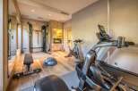 This home gym boasts state-of-the-art equipment, including a treadmill, spinning bike, and weight training station, making it ideal for fitness enthusiasts.