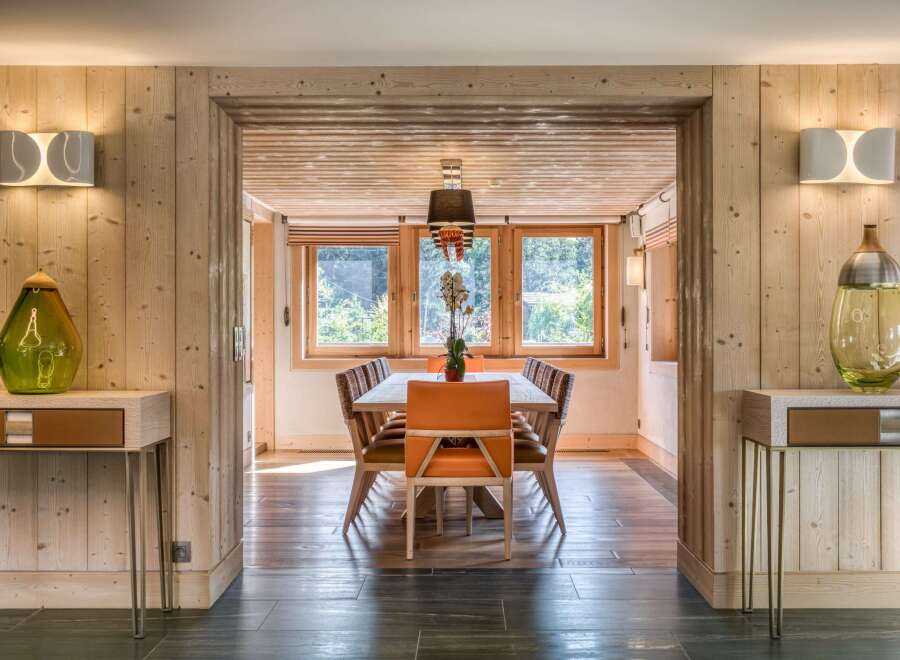 Step inside this inviting dining area, where warm wood paneling creates a cozy, rustic atmosphere.