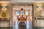 Step inside this inviting dining area, where warm wood paneling creates a cozy, rustic atmosphere.