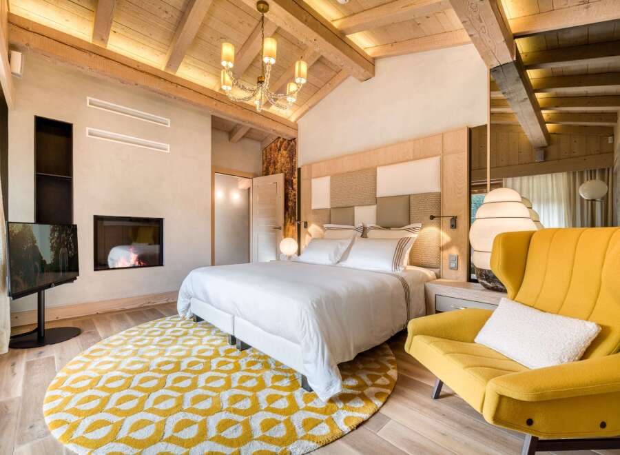 This stunning bedroom boasts a harmonious blend of rustic charm and modern luxury.