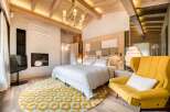 This stunning bedroom boasts a harmonious blend of rustic charm and modern luxury.