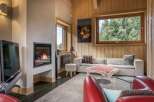 Discover the cozy ambiance of this inviting living room, featuring a modern fireplace as its focal point.