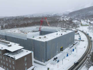 Midtown Niseko, a premier real estate development, is captured in this aerial view amidst a snowy landscape.