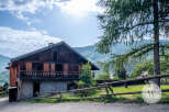 Discover this charming mountain chalet with traditional wooden architecture, nestled in a serene landscape.