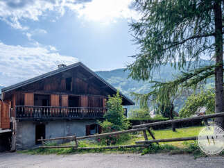 Discover this charming mountain chalet with traditional wooden architecture, nestled in a serene landscape.