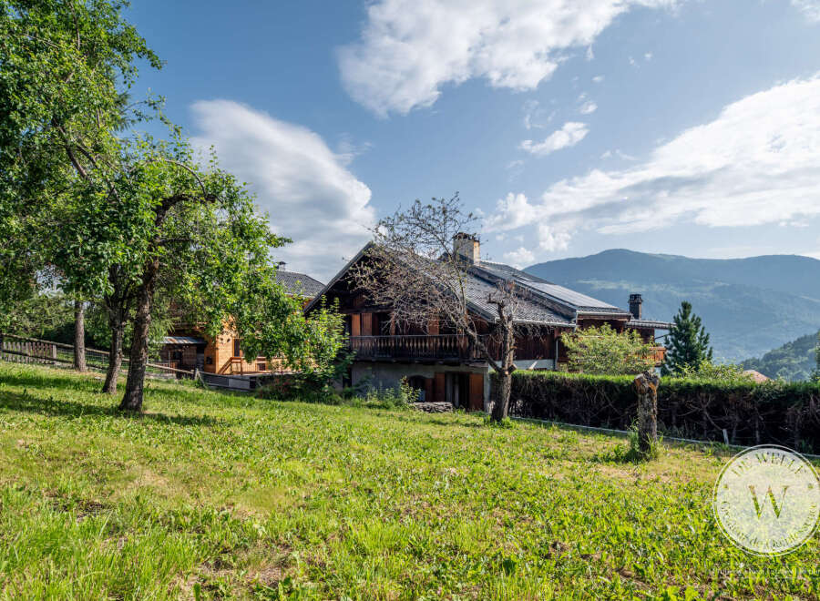 Nestled in a serene landscape, this charming chalet offers a tranquil retreat with stunning mountain views.