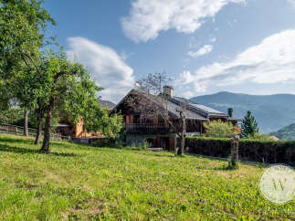 Nestled in a serene landscape, this charming chalet offers a tranquil retreat with stunning mountain views.