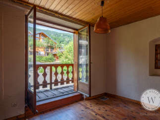 This room boasts beautiful wooden floors and ceiling, creating a warm and inviting ambiance.