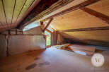 Discover the untapped potential of this attic space with its exposed wooden beams and unique architectural details.