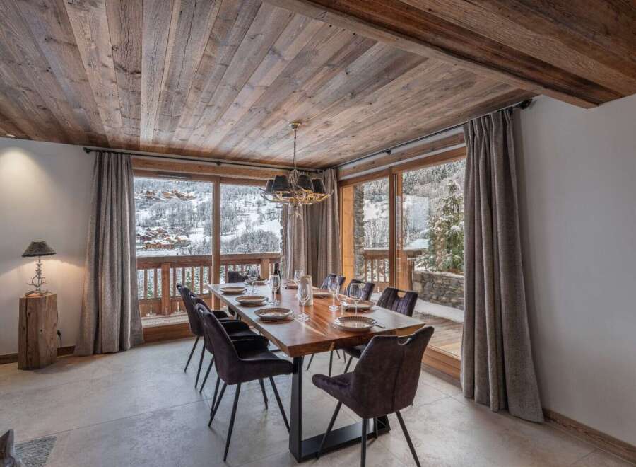 This dining area features a solid wood table perfect for gathering with loved ones.
