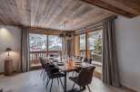 This dining area features a solid wood table perfect for gathering with loved ones.
